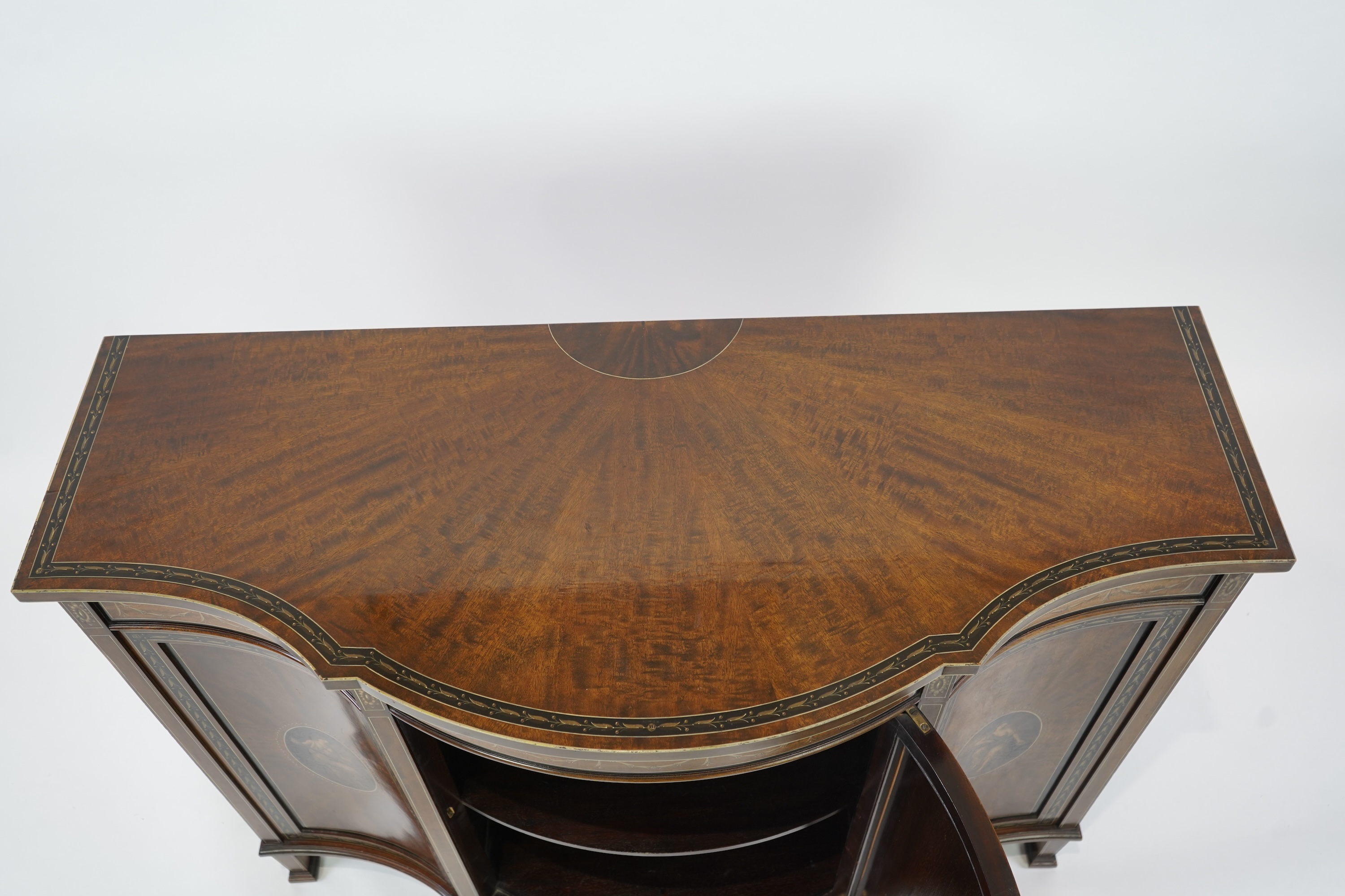 An Edwardian Sheraton Revival painted mahogany bowfront side cabinet